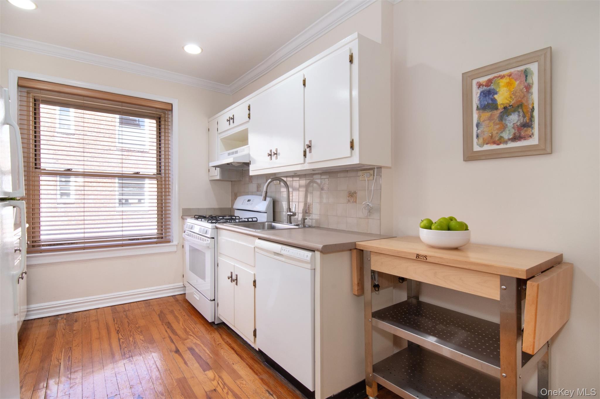 250 Bronxville Road, Unit 5A Bronxville, NY 10708 - Photo 6 of 20 a kitchen with a stove a sink and a window