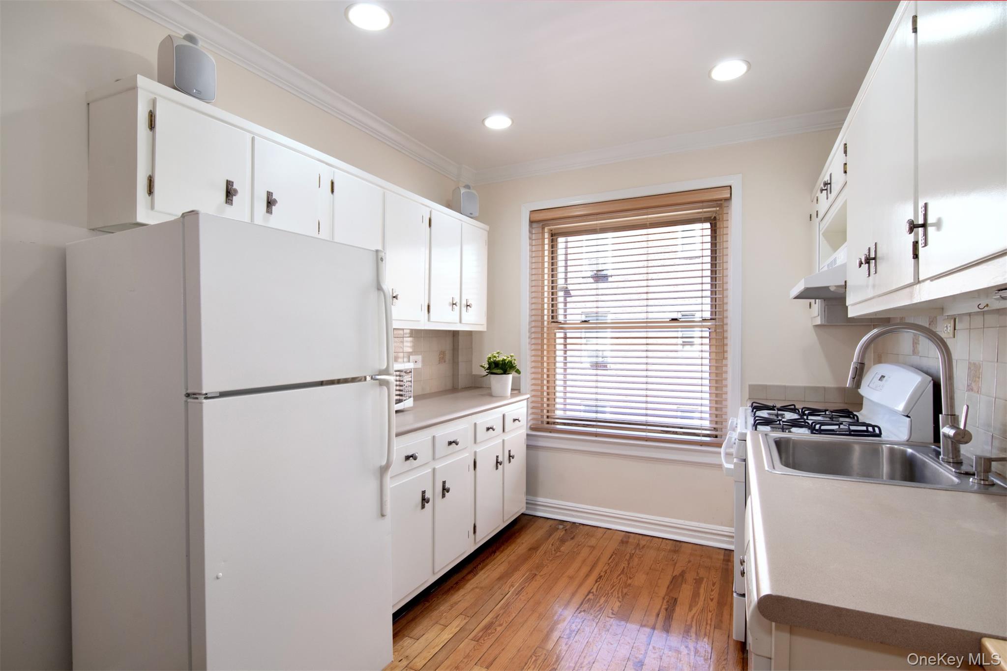 250 Bronxville Road, Unit 5A Bronxville, NY 10708 - Photo 7 of 20 a kitchen with stainless steel appliances a refrigerator sink and cabinets
