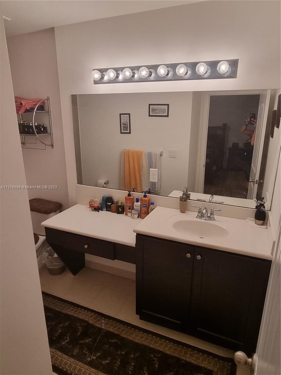 27534 Southwest 140th Avenue Homestead, FL 33032 - Photo 14 of 25 a bathroom with a sink and mirror