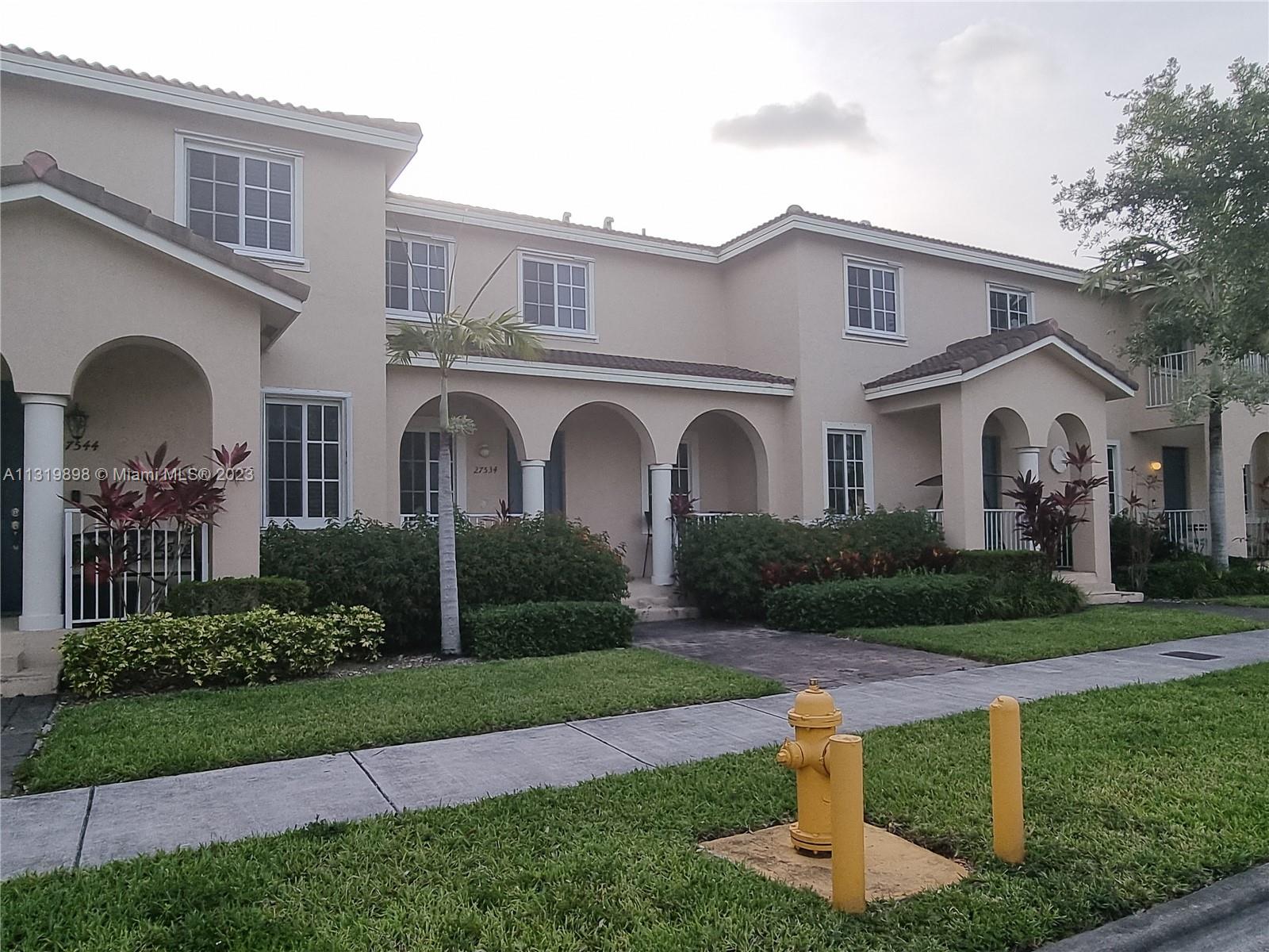 27534 Southwest 140th Avenue Homestead, FL 33032 - Photo 2 of 25 a front view of a house with a garden and plants