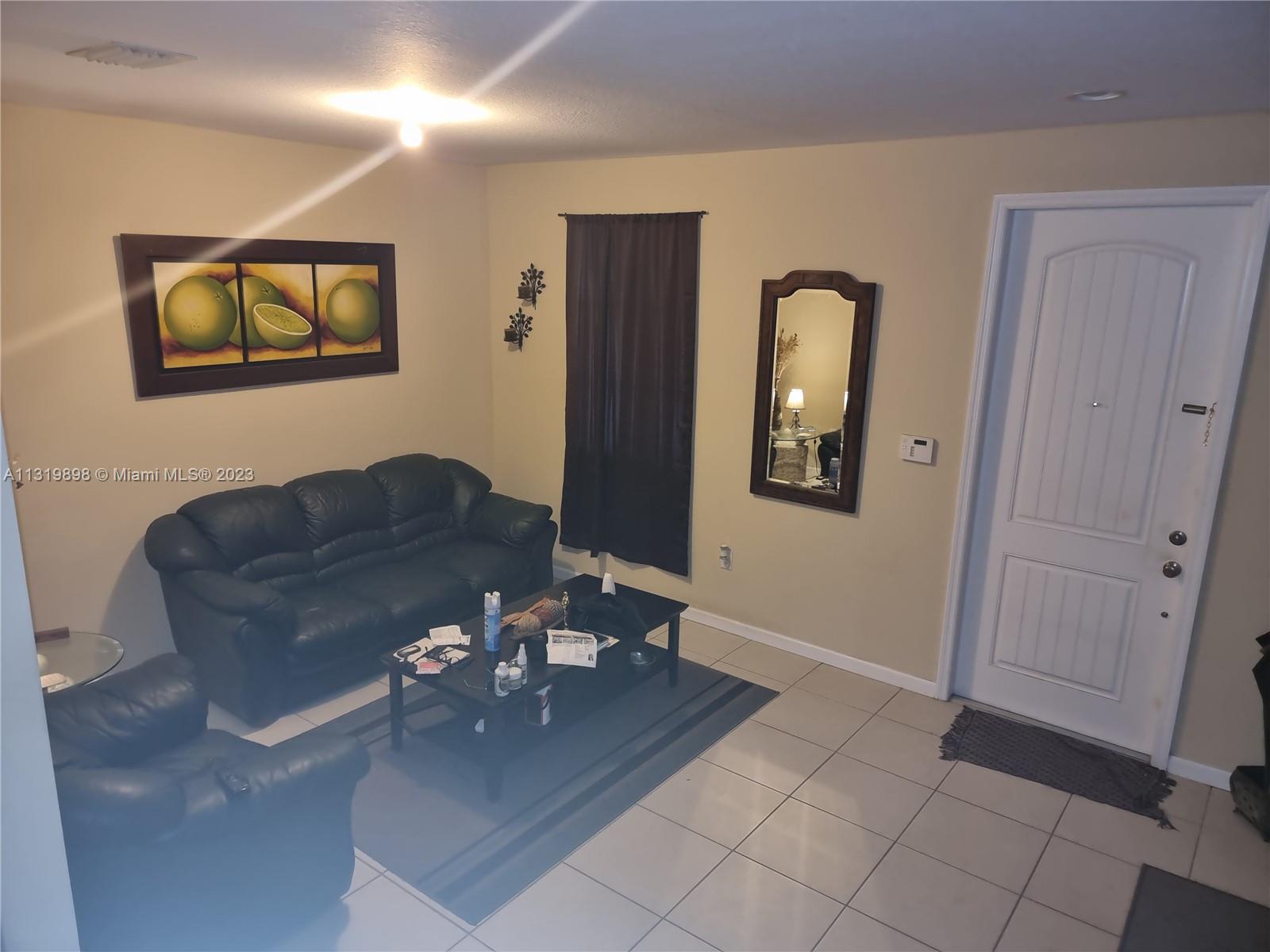 27534 Southwest 140th Avenue Homestead, FL 33032 - Photo 5 of 25 a living room with couches and painting on the wall