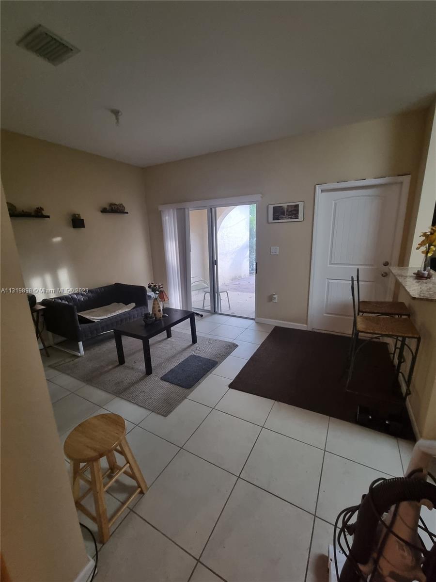 27534 Southwest 140th Avenue Homestead, FL 33032 - Photo 6 of 25 a living room with furniture and a lamp