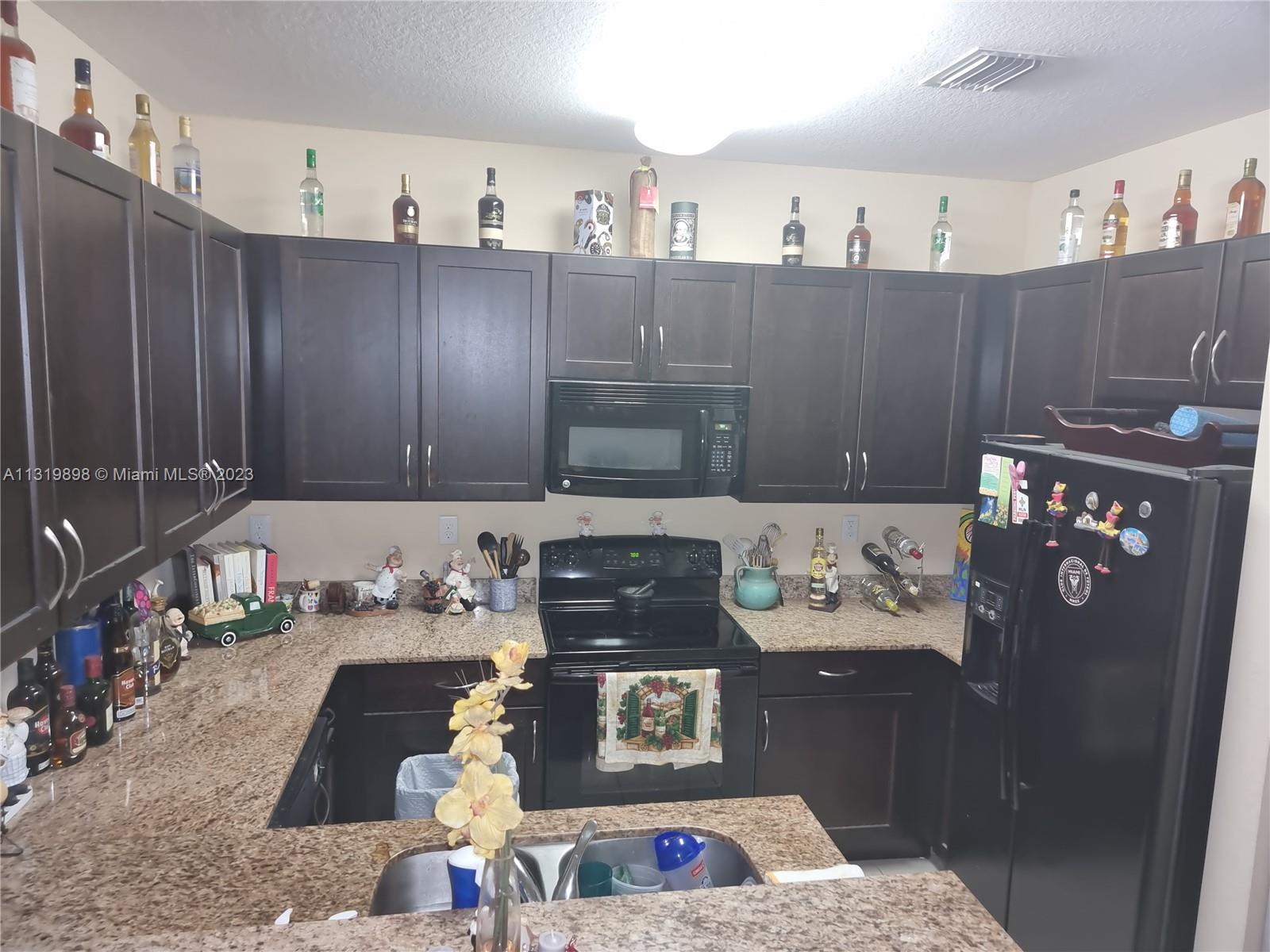 27534 Southwest 140th Avenue Homestead, FL 33032 - Photo 7 of 25 a living room with hard wood flooring and a couch