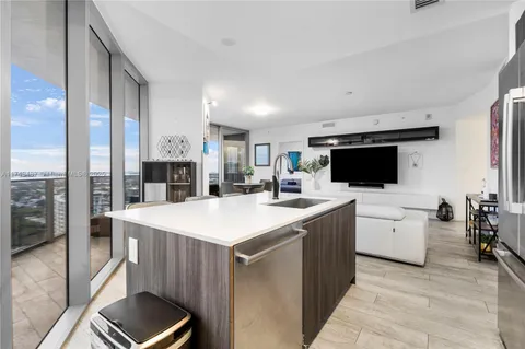 a large kitchen with a large counter top appliances and cabinets