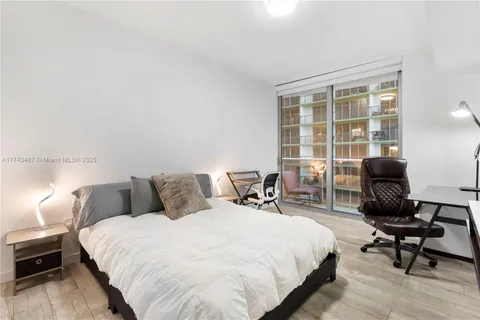 a bedroom with bed and a window