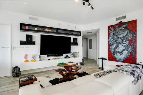 a room with furniture and a flat screen tv