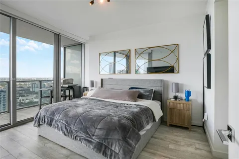 a bedroom with a large bed and a large window