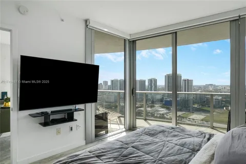 a living room with a large window and a flat screen tv