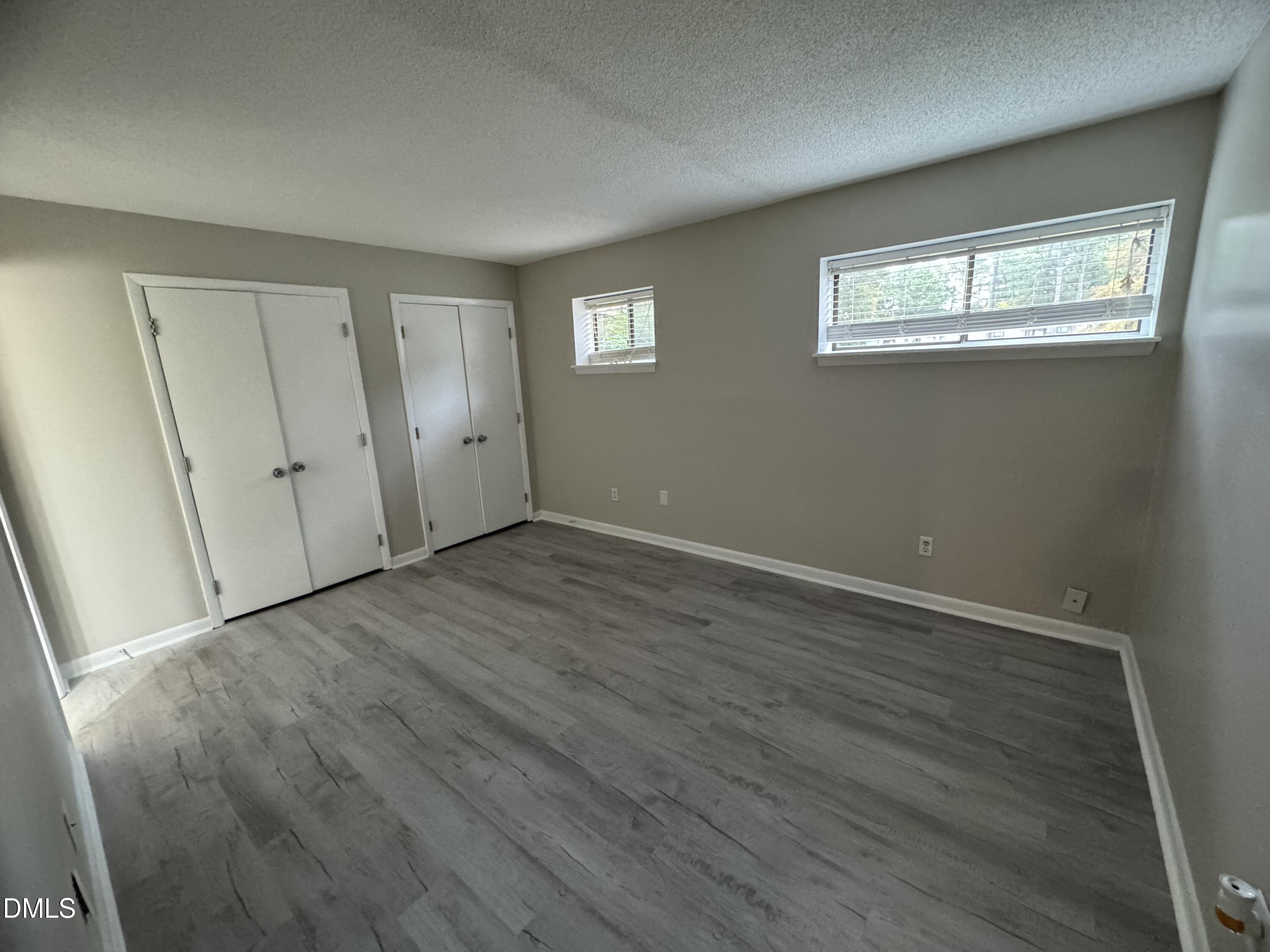 533 Pine Ridge Place Raleigh, NC 27609 - Photo 5 of 13 a view of an empty room with wooden floor and a window