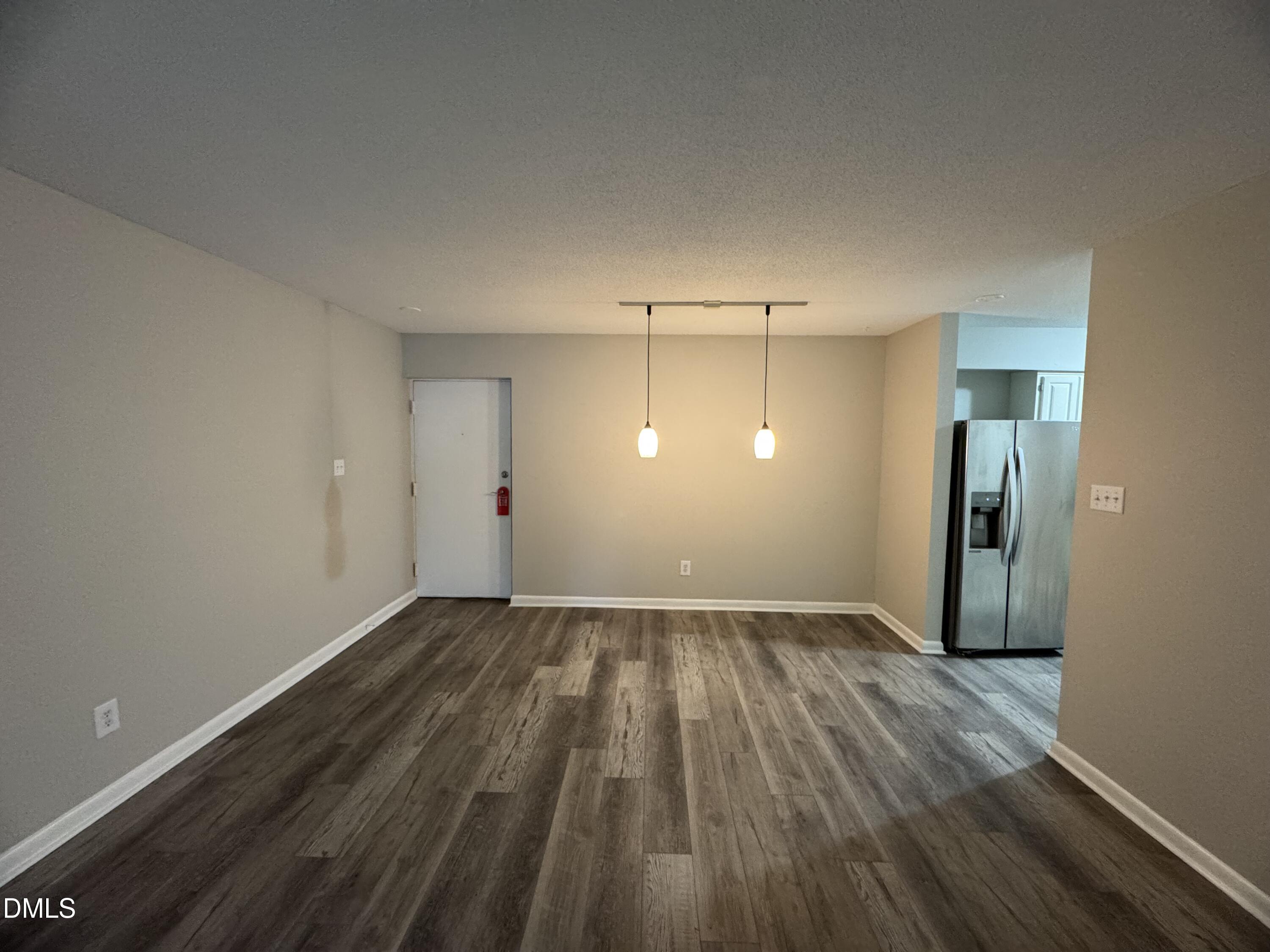 533 Pine Ridge Place Raleigh, NC 27609 - Photo 6 of 13 a view of an empty room with wooden floor and closet
