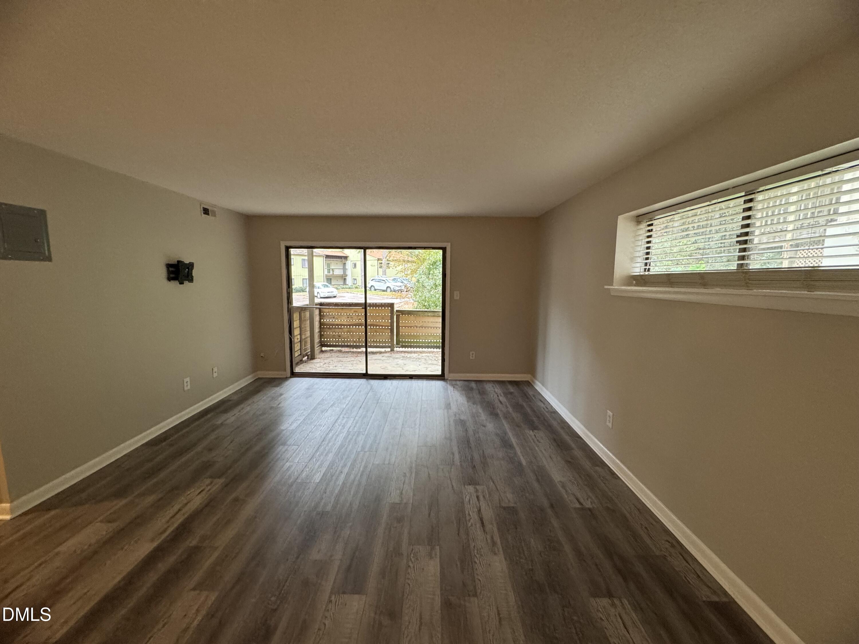 533 Pine Ridge Place Raleigh, NC 27609 - Photo 7 of 13 an empty room with wooden floor and windows