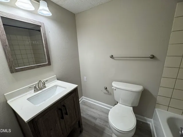 a white toilet sitting next to a bathroom sink