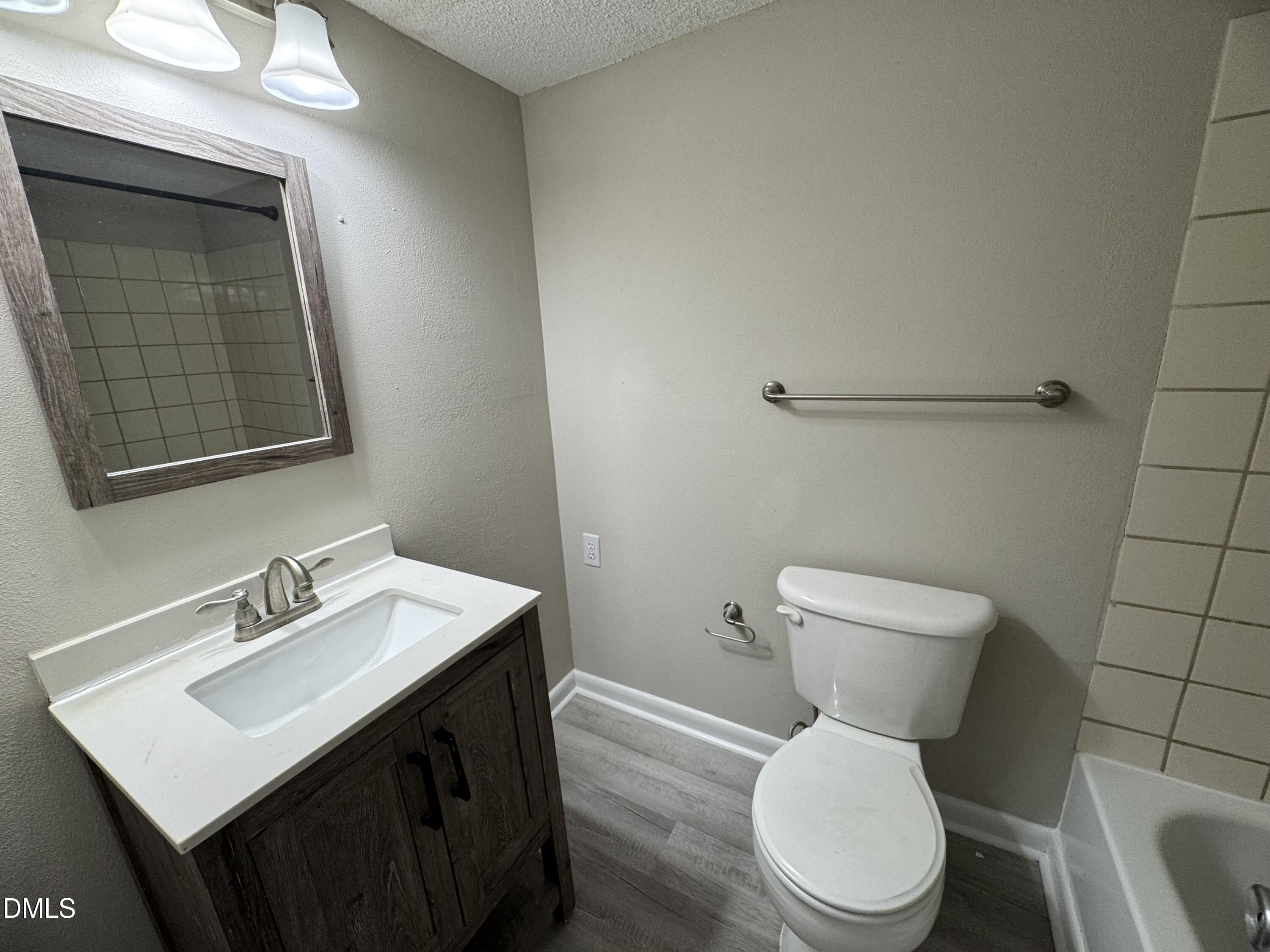 533 Pine Ridge Place Raleigh, NC 27609 - Photo 8 of 13 a white toilet sitting next to a bathroom sink