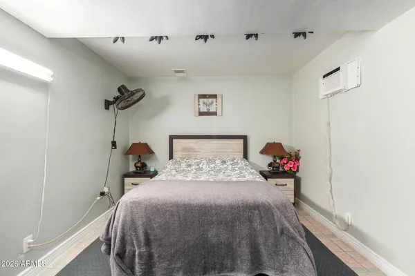a bed room with a bed and a wooden floor