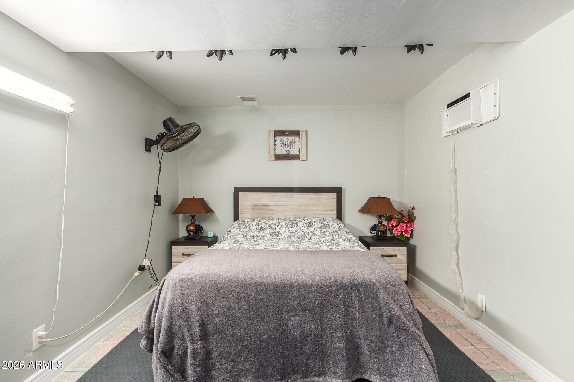 2825 North 33rd Place Phoenix, AZ 85008 - Photo 15 of 27 a bed room with a bed and a wooden floor