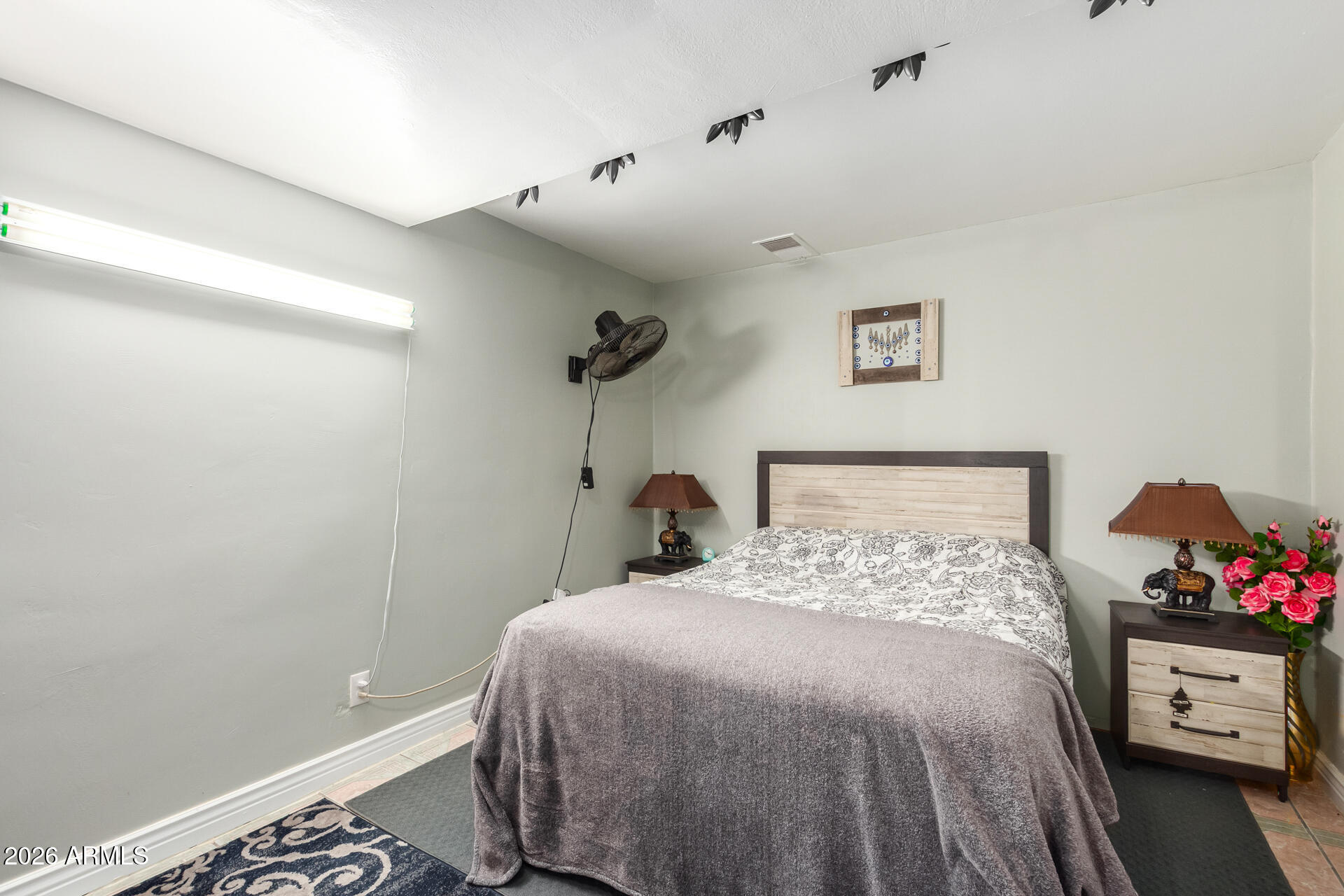 2825 North 33rd Place Phoenix, AZ 85008 - Photo 16 of 27 a bedroom with a bed and a potted plant on the dresser