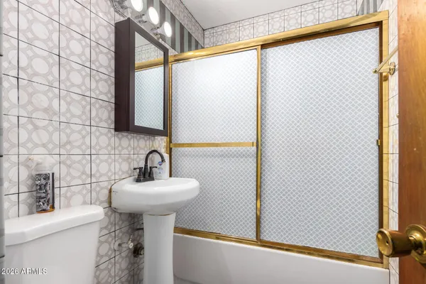 a bathroom with a sink and mirror