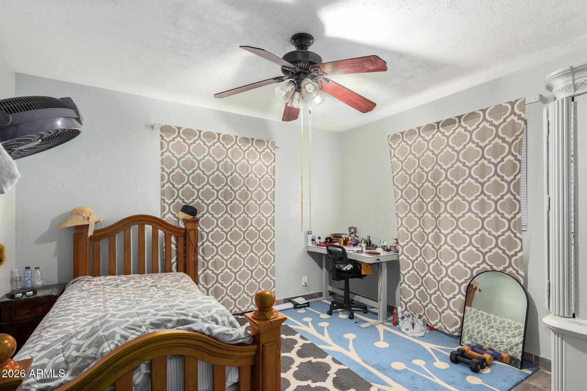 2825 North 33rd Place Phoenix, AZ 85008 - Photo 22 of 27 a bedroom with a bed and a chandelier