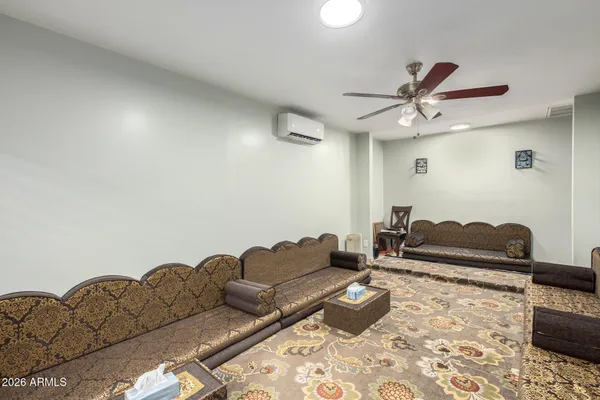 a living room with furniture and a rug