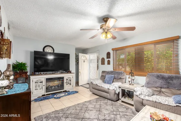 a living room with furniture a flat screen tv and a fireplace