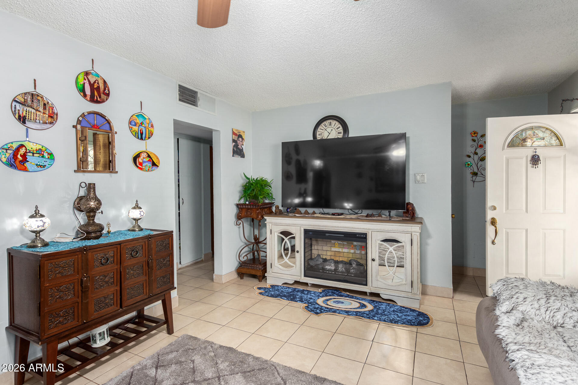 2825 North 33rd Place Phoenix, AZ 85008 - Photo 8 of 27 a living room with furniture and a flat screen tv