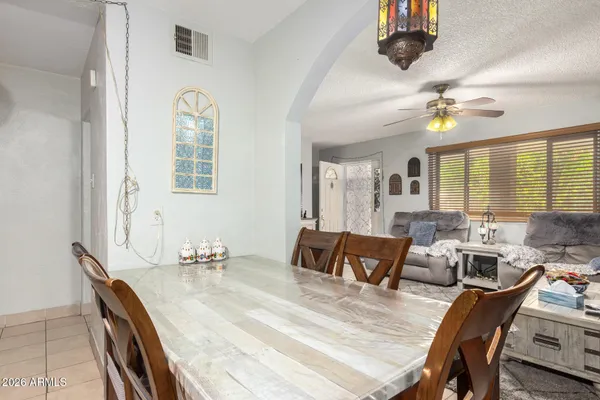 a view of a a dining room with furniture window and wooden floor