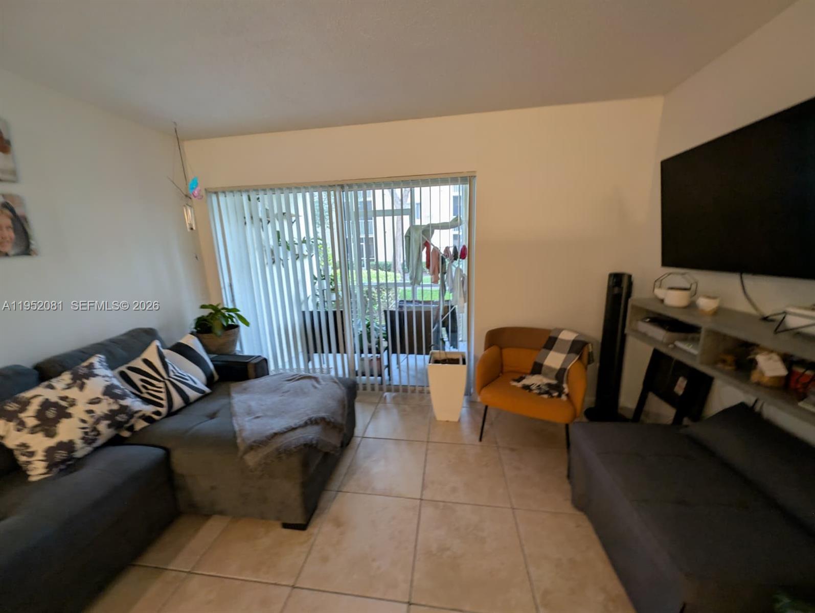 430 South Park Road, Unit 3108 Hollywood, FL 33021 - Photo 4 of 7 a living room with furniture and a flat screen tv
