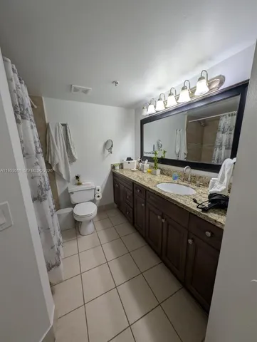 a kitchen with a sink a stove and cabinets