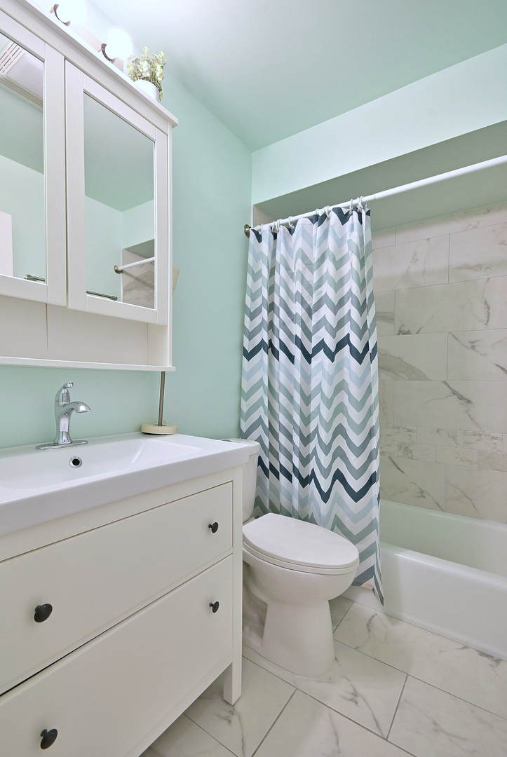 836 East Old Willow Road, Unit 211 Prospect Heights, IL 60070 - Photo 16 of 28 a bathroom with a sink toilet and shower