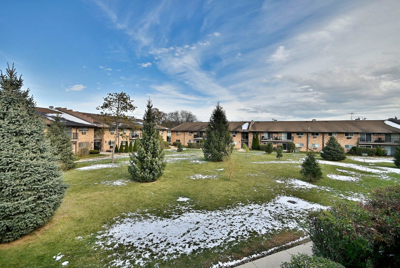 836 East Old Willow Road, Unit 211 Prospect Heights, IL 60070 - Photo 23 of 28 a view of a big house with a big yard and potted plants