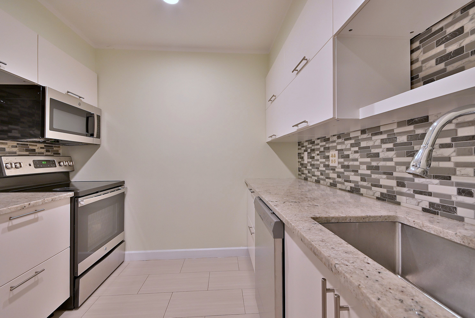 836 East Old Willow Road, Unit 211 Prospect Heights, IL 60070 - Photo 8 of 28 a kitchen with granite countertop a sink and a stove top oven with wooden floor