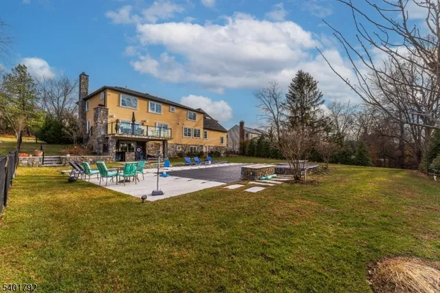 a view of a swimming pool with a bench and lawn chairs