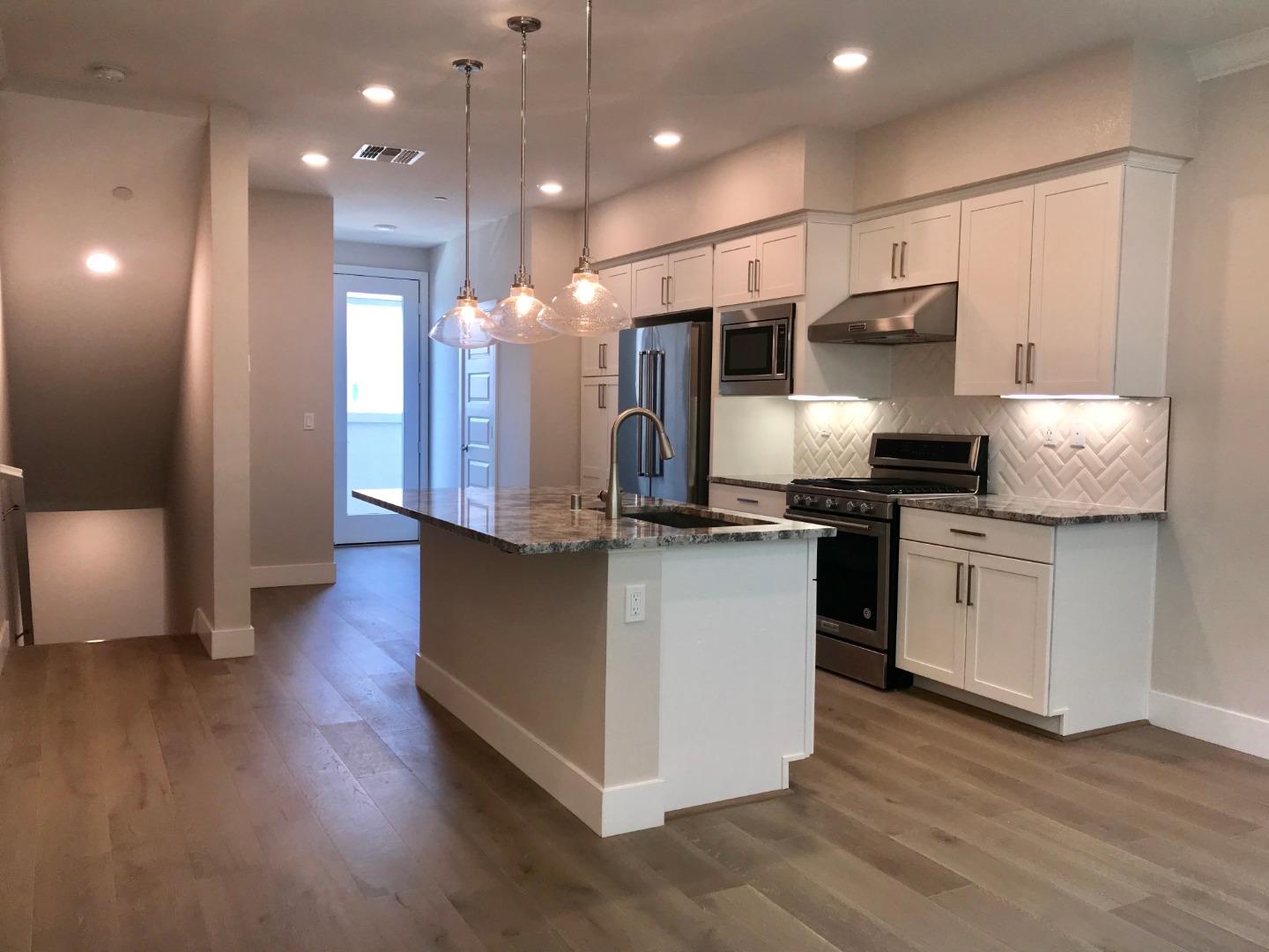 1506 Cherry Circle Milpitas, CA 95035 - Photo 2 of 12 a kitchen with stainless steel appliances kitchen island granite countertop a stove a sink and a refrigerator