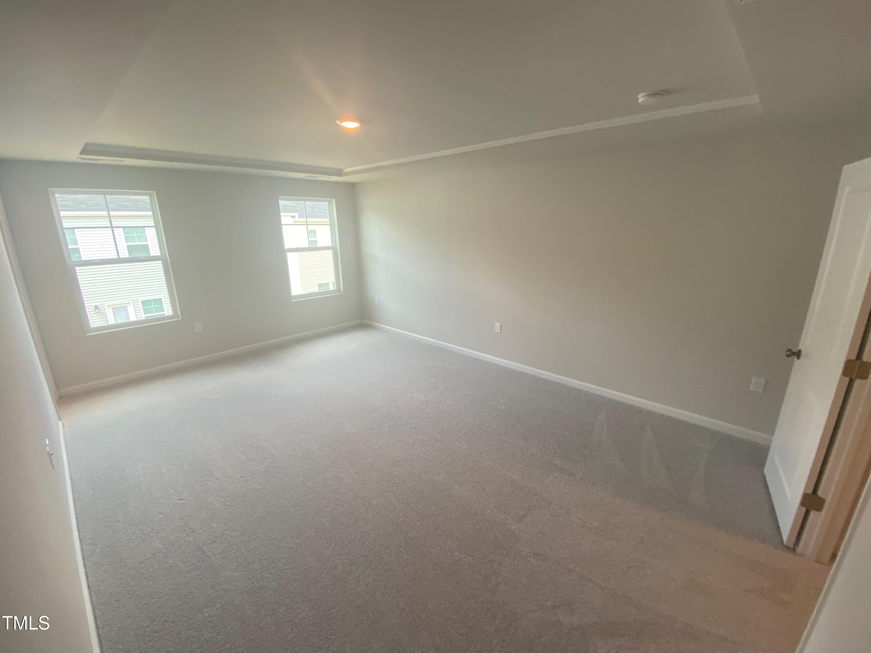 247 Paramount Drive, Unit 104 Smithfield, NC 27577 - Photo 6 of 7 an empty room with windows and closet