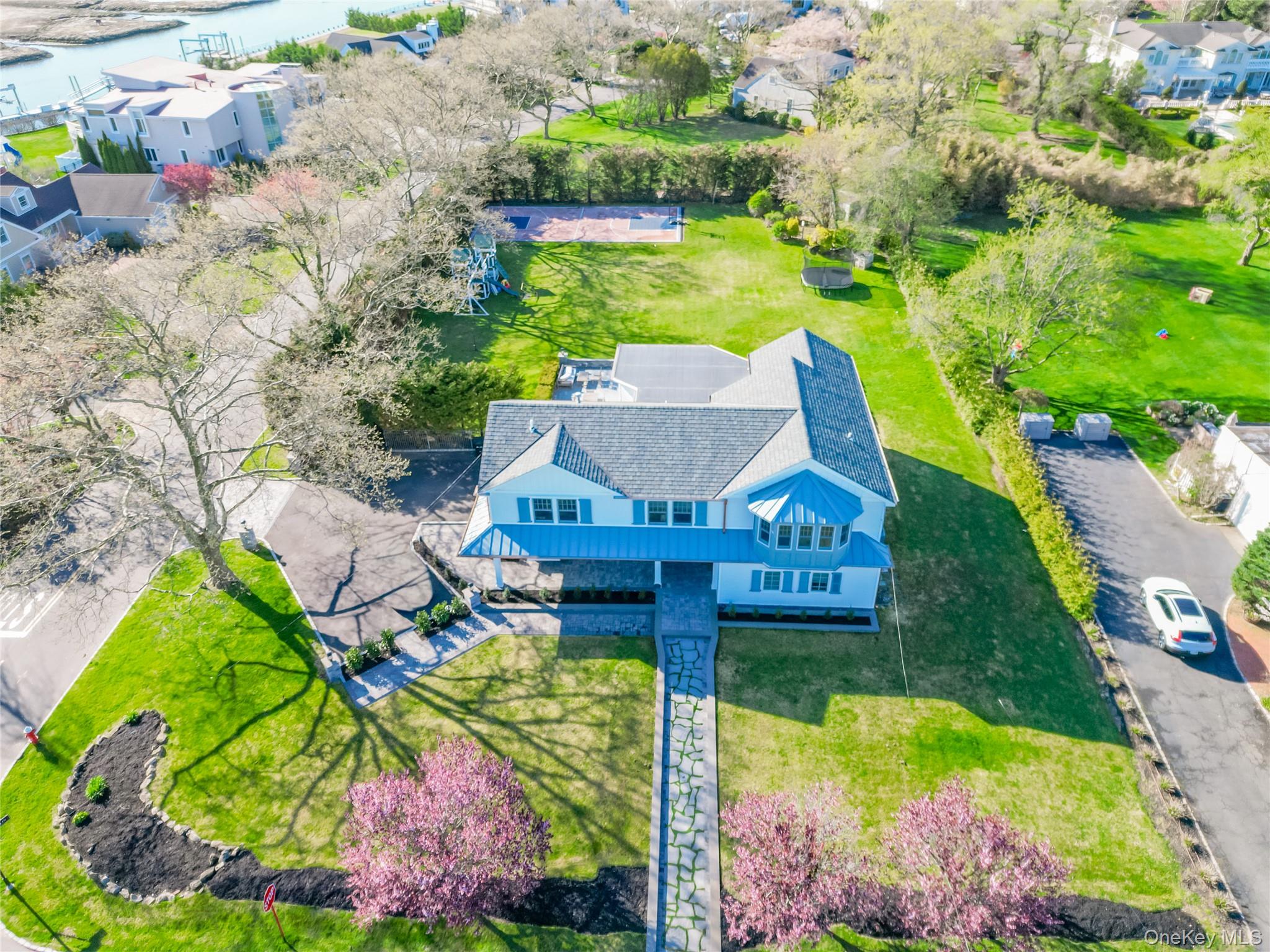 315 Hewlett Neck Road Woodmere, NY 11598 - Photo 34 of 37 a aerial view of a house with a garden and lake view