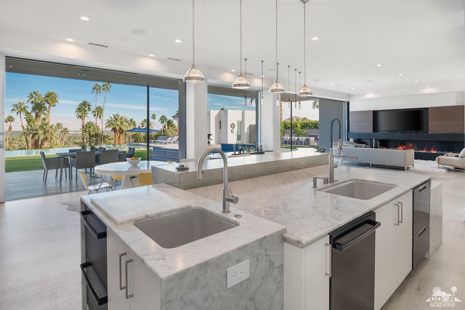 70262 Sonora Road Rancho Mirage, CA 92270 - Photo 11 of 24 a kitchen with stainless steel appliances a sink a counter top space appliances and a large window