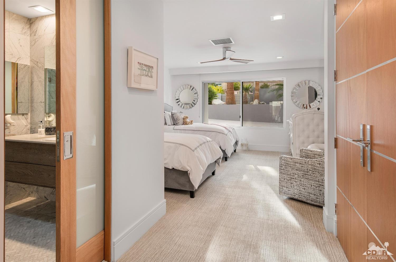 70262 Sonora Road Rancho Mirage, CA 92270 - Photo 17 of 24 a spacious bedroom with a bed and large window