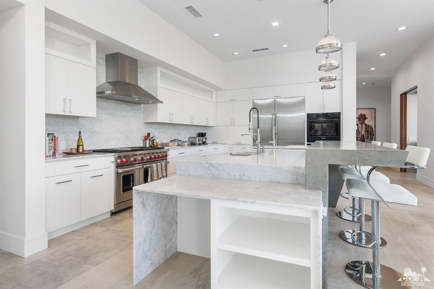 70262 Sonora Road Rancho Mirage, CA 92270 - Photo 10 of 24 a kitchen with stainless steel appliances granite countertop a sink counter space and cabinets