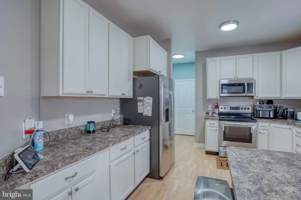 a kitchen with stainless steel appliances granite countertop a sink and cabinets