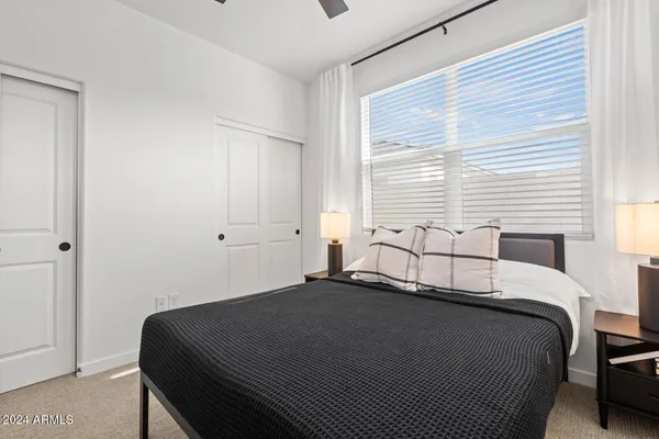 a bedroom with a bed and a dresser