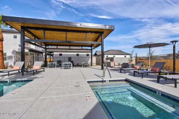 a patio with a table and chairs under an umbrella