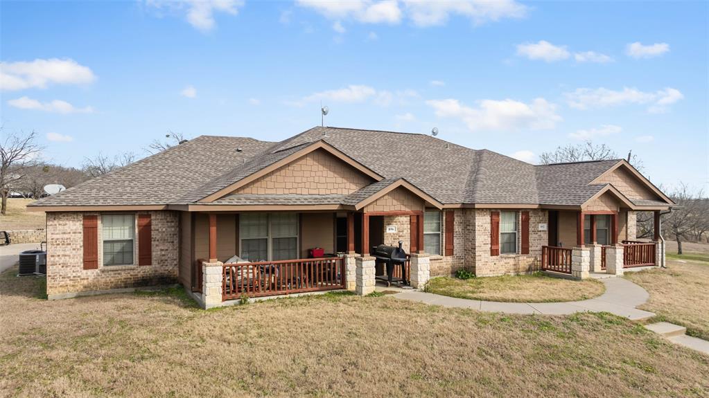 892 West First Street Maypearl, TX 76064 - Photo 2 of 18 a front view of a house with a yard and garage