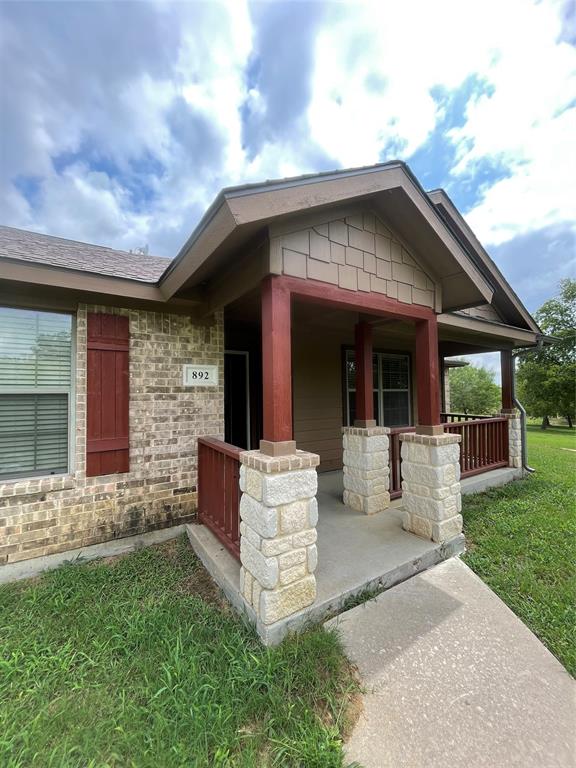 892 West First Street Maypearl, TX 76064 - Photo 4 of 18 a front view of a house with garden