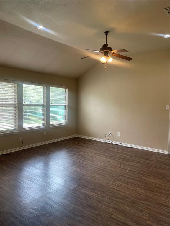 892 West First Street Maypearl, TX 76064 - Photo 6 of 18 a view of an empty room with wooden floor and a window