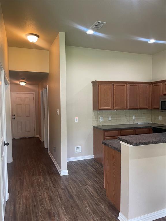 892 West First Street Maypearl, TX 76064 - Photo 8 of 18 a view of a kitchen cabinets and wooden floor