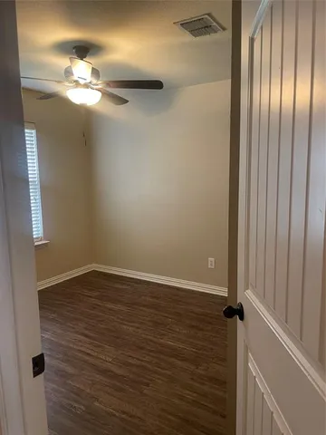 wooden floor in an empty room with a mirror