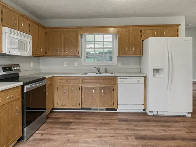 a kitchen with a sink a stove and cabinets