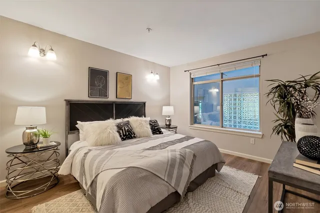 a bedroom with a bed and a painting on the wall