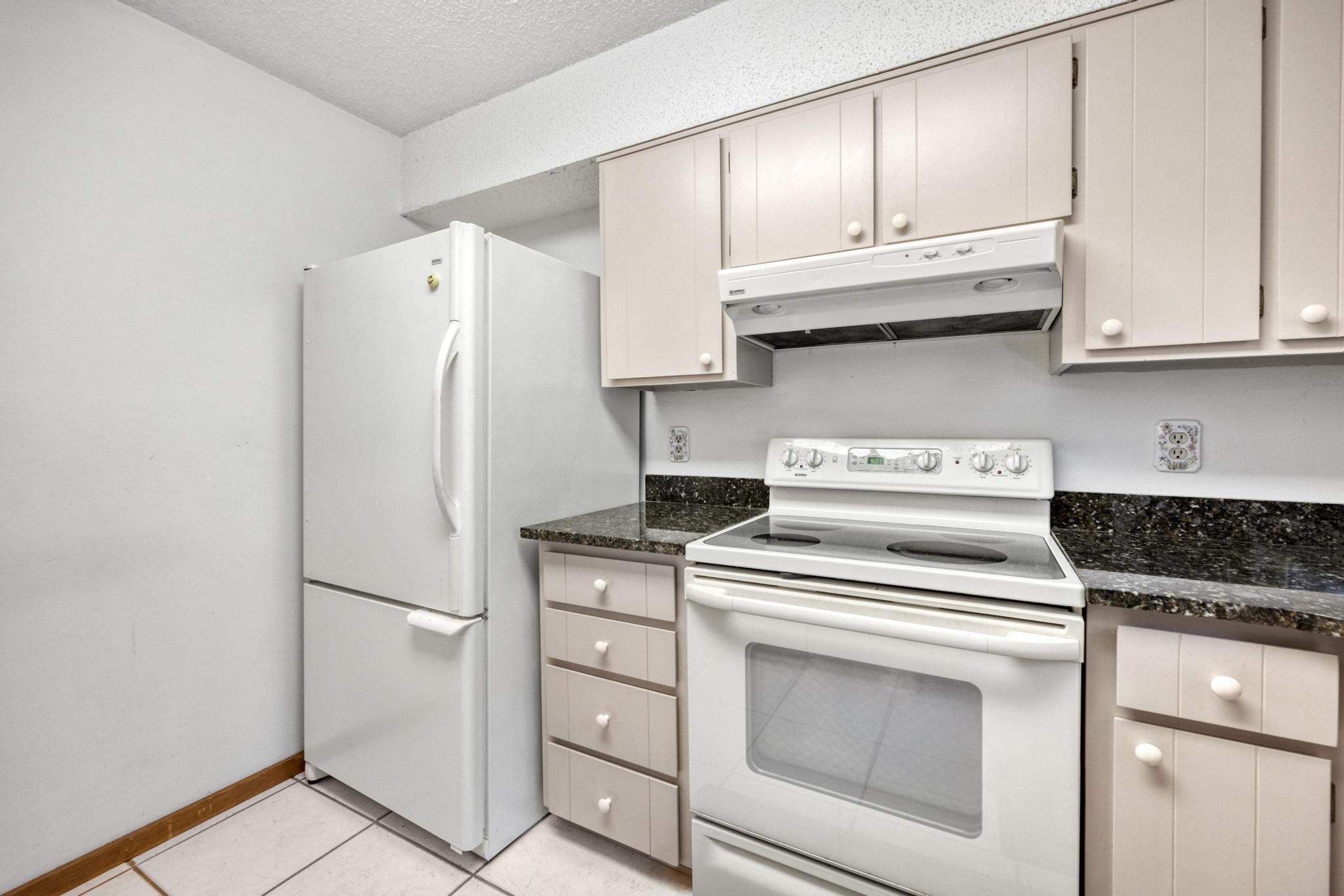 6079 Clear Creek Road Crestview, FL 32539 - Photo 17 of 58 a kitchen with white cabinets and white appliances