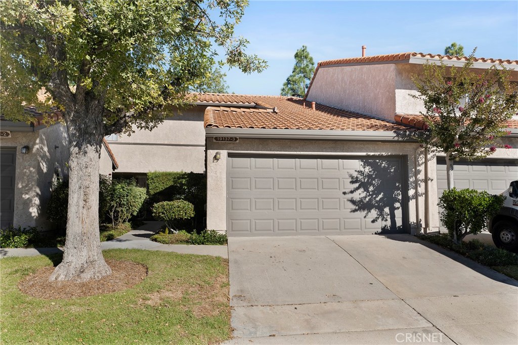 19137 Index Street, Unit 3 Porter Ranch, CA 91326 - Photo 1 of 1 a front view of a house with garden